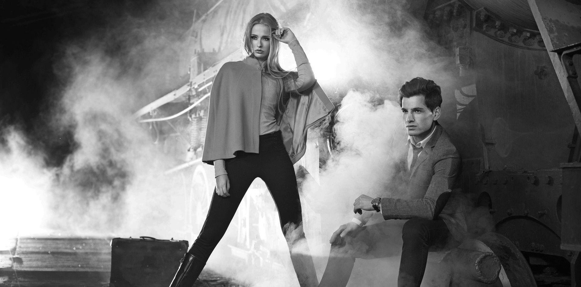 Fashion picture of two models next to the engine